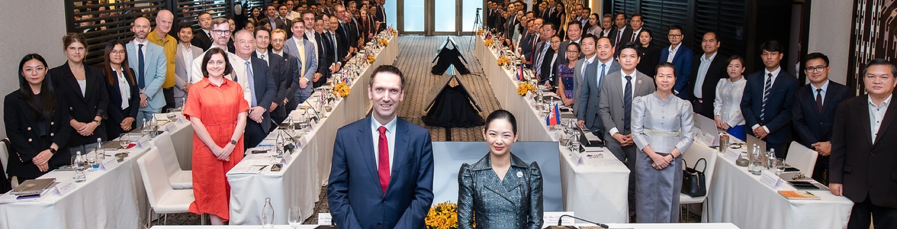 BritCham Cambodia and British Embassy representatives at a formal dialogue with Cambodian government officials, UK and Cambodian flags on the table